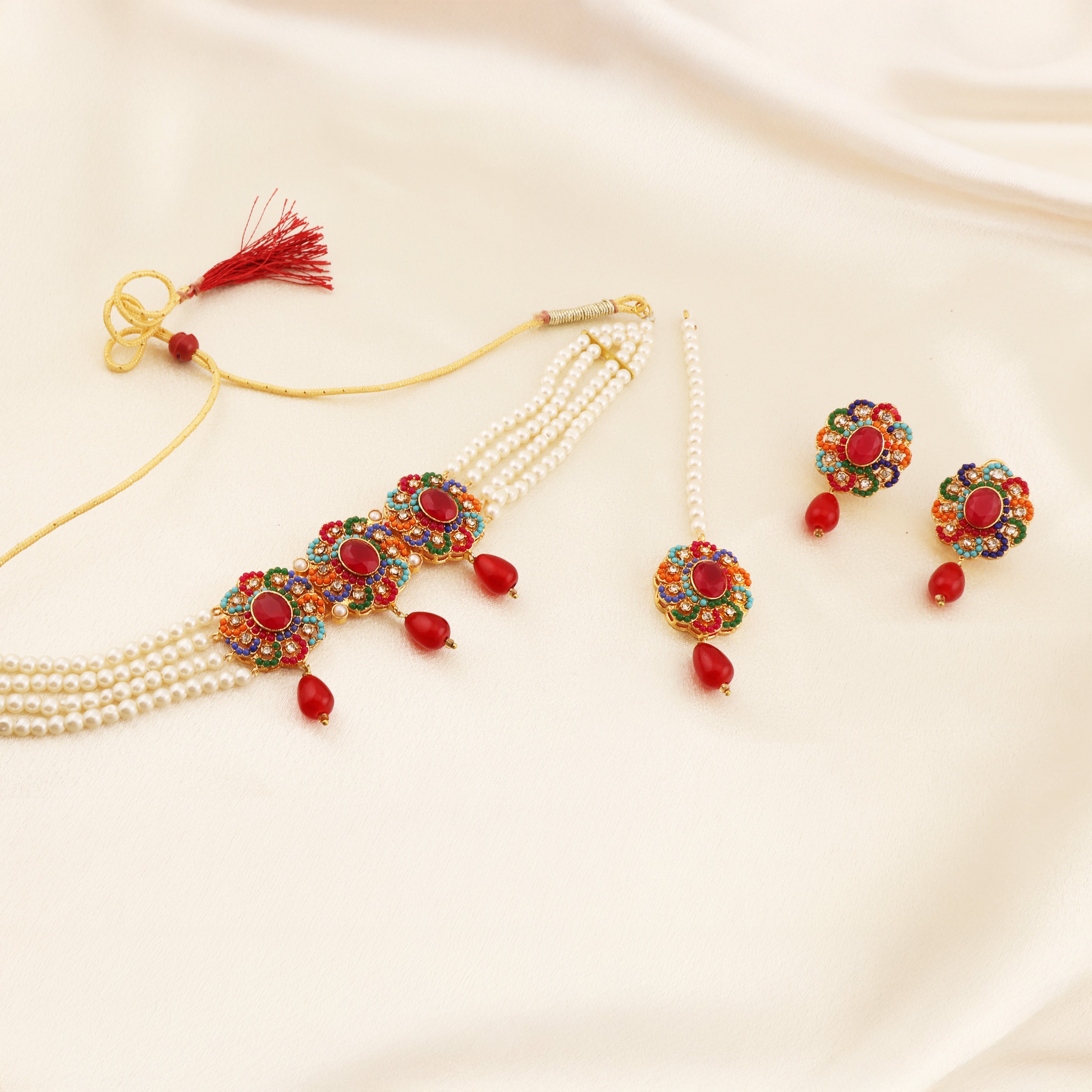 A ZARIAH ruby-red kundan-style full set with deep red stones set in gold framing