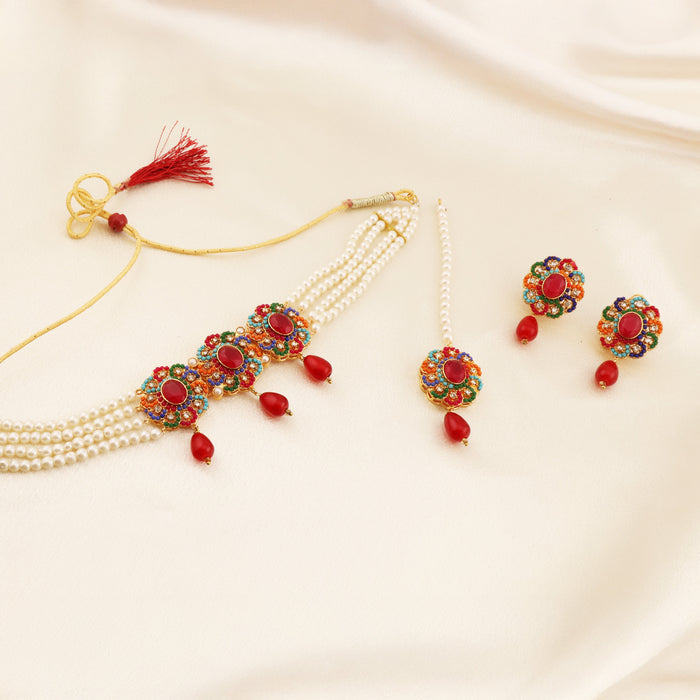 A ZARIAH ruby-red kundan-style full set with deep red stones set in gold framing