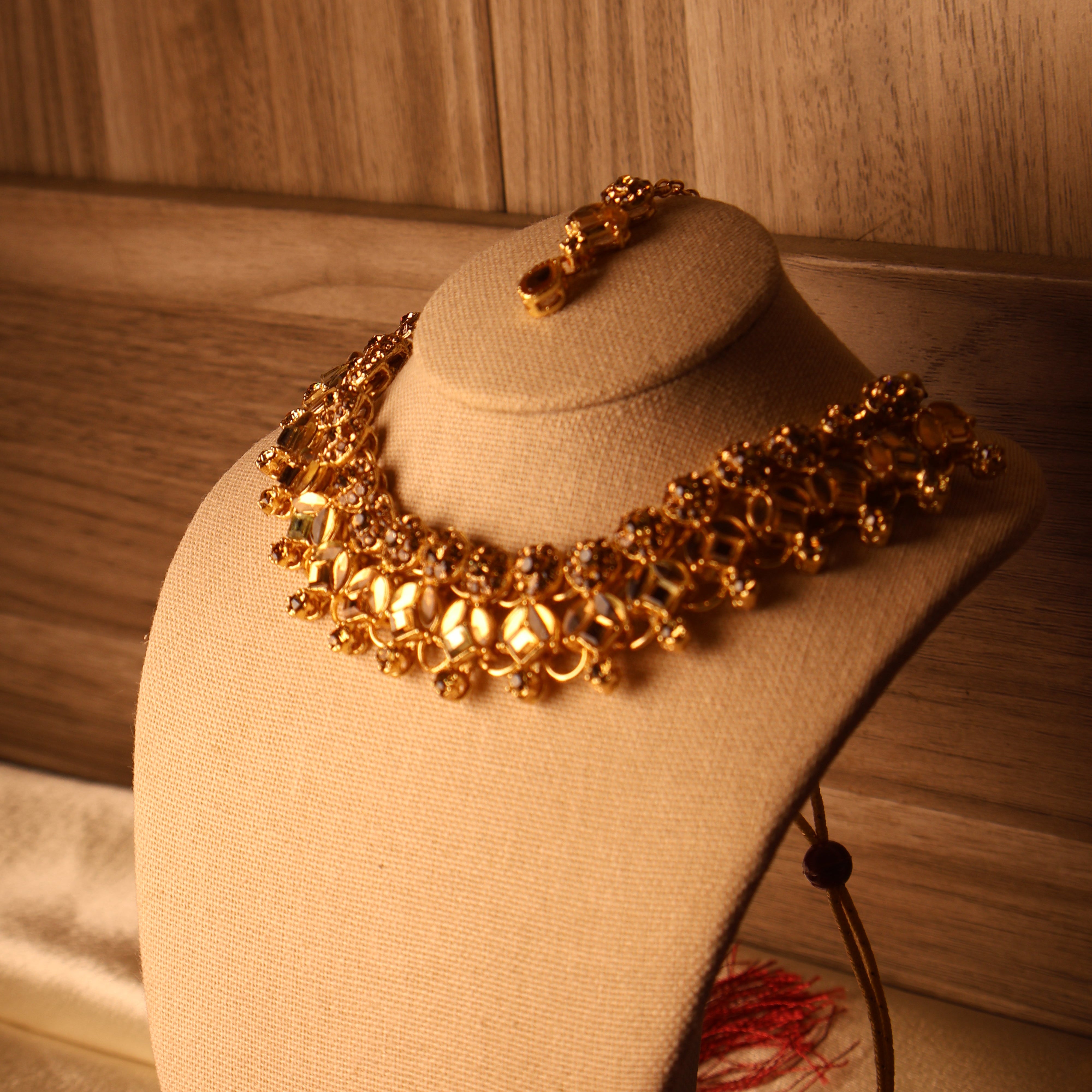 MUMTAZ champagne and gold kundan-style set with long drop earrings and tikka